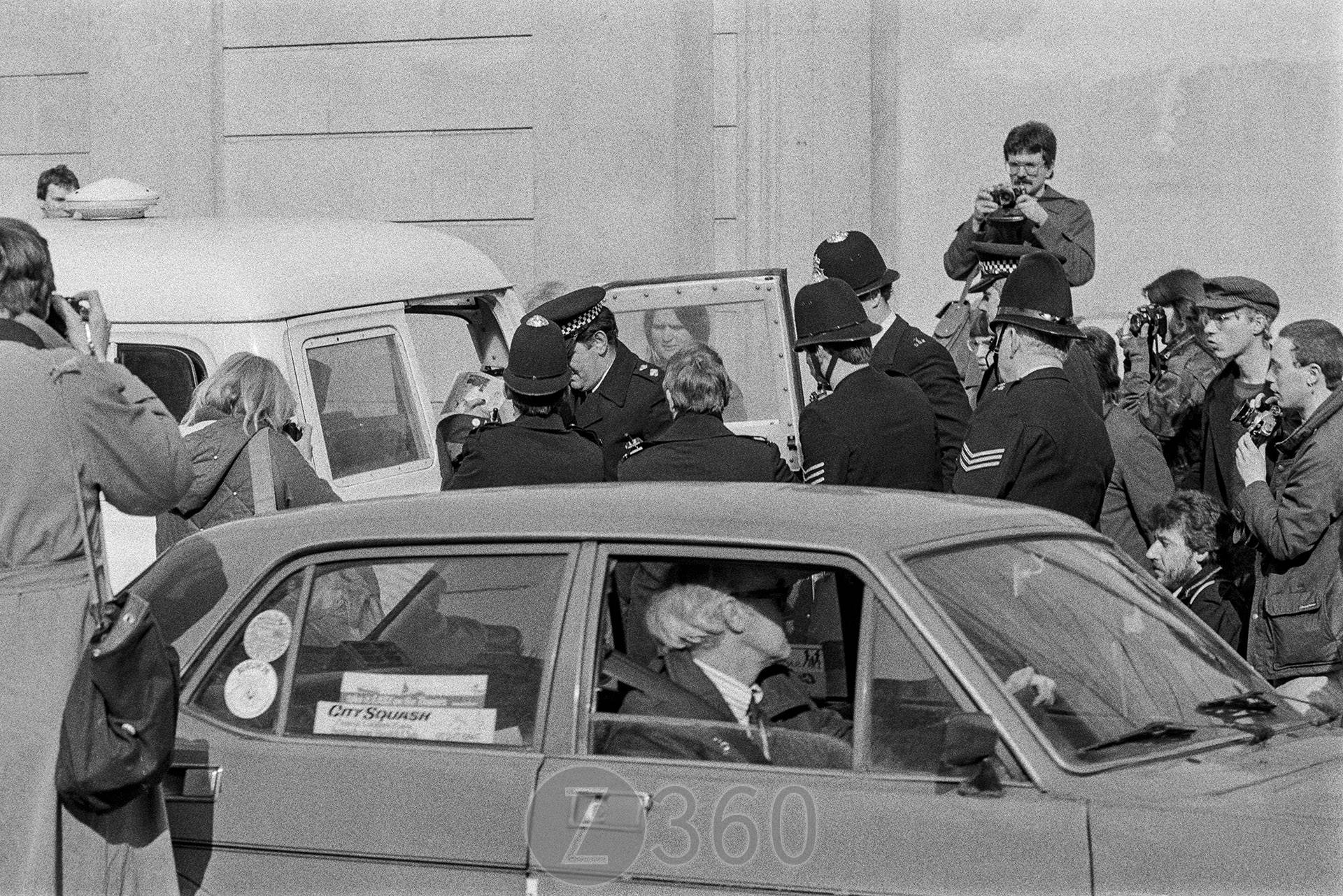 Protestor loaded into van
